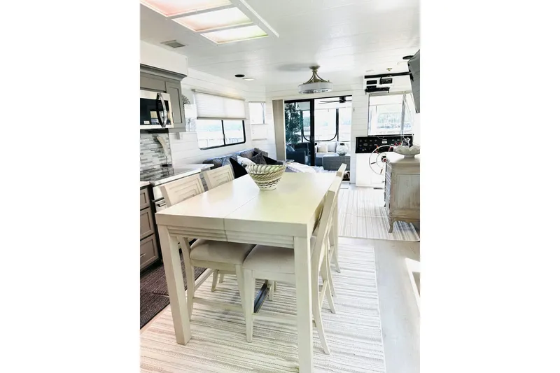 Slide: The Image of Modern kitchen interior in a 1992 Sumerset 66 houseboat with sleek cabinetry and dining area. - 8