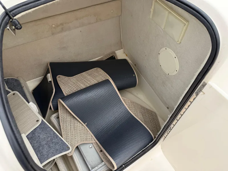 Slide: The Image of Storage compartment of 1999 Chaparral Sunesta 232 boat with mats and accessories. - 11