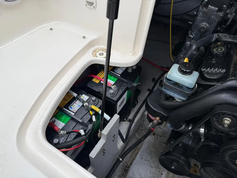 Slide: The Image of 1999 Chaparral Sunesta 232 boat engine compartment with batteries and mechanical components. - 14