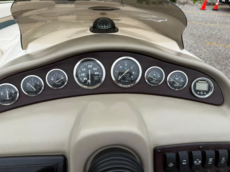 Slide: The Image of Dashboard of a 1999 Chaparral Sunesta 232 boat with gauges and controls. - 16