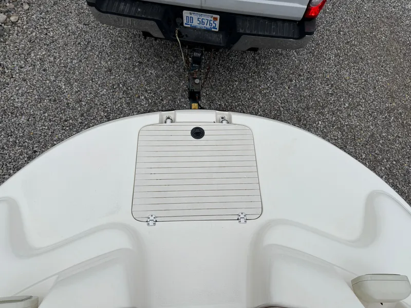 Slide: The Image of 1999 Chaparral Sunesta 232 boat hitched to a vehicle on gravel. - 17