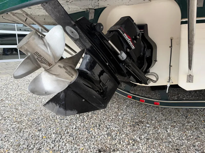 Slide: The Image of 1999 Chaparral Sunesta 232 boat propeller and outdrive on gravel surface. - 19