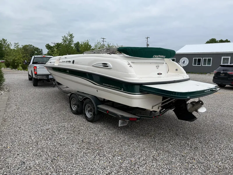 Slide: The Image of 1999 Chaparral Sunesta 232 boat on trailer, parked on gravel driveway. - 3