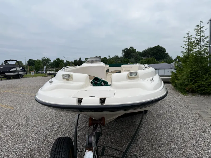 Slide: The Image of 1999 Chaparral Sunesta 232 boat on trailer, parked on gravel lot. - 6