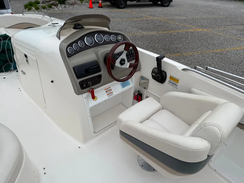 Slide: The Image of 1999 Chaparral Sunesta 232 boat cockpit with steering wheel and control panel. - 9