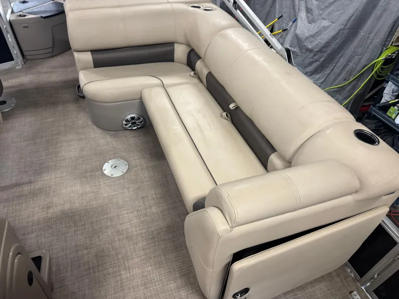 Slide: The Image of 2023 Sun Tracker SportFish 20 DLX boat interior with beige seating and cup holders. - 11