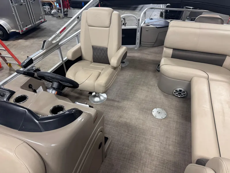 Slide: The Image of 2023 Sun Tracker SportFish 20 DLX interior with beige seating and steering console. - 12