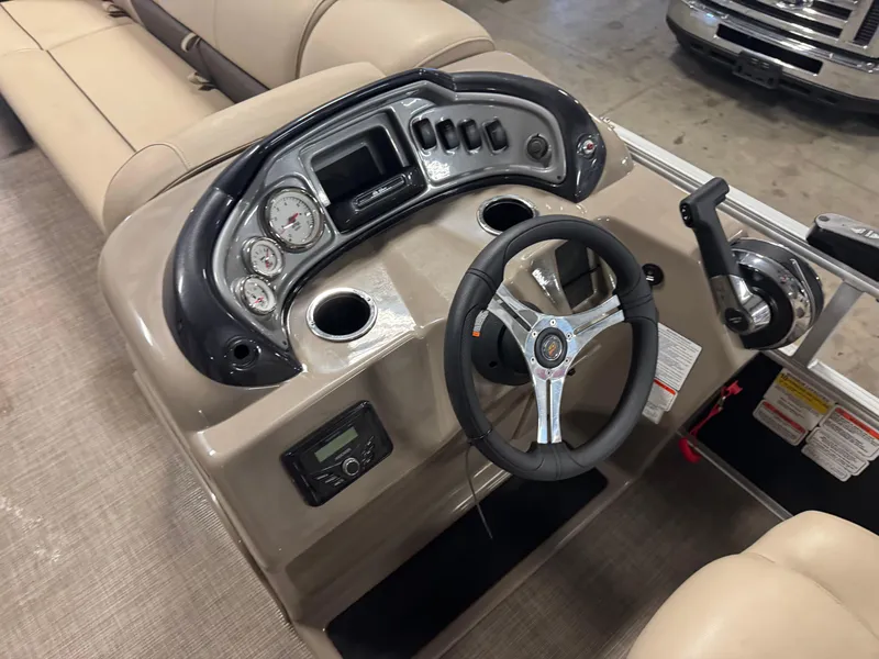Slide: The Image of 2023 Sun Tracker SportFish 20 DLX boat dashboard with steering wheel and control panel. - 13