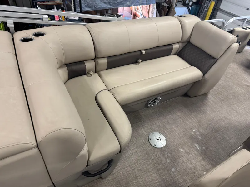 Slide: The Image of 2023 Sun Tracker SportFish 20 DLX boat interior with beige seating and cup holders. - 17