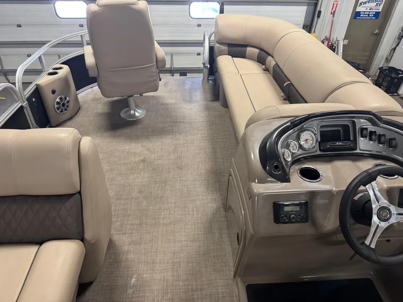 Slide: The Image of 2023 Sun Tracker SportFish 20 DLX interior with beige seating and modern dashboard. - 18