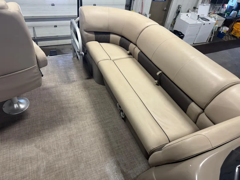 Slide: The Image of 2023 Sun Tracker SportFish 20 DLX interior with beige seating and carpeted flooring. - 19
