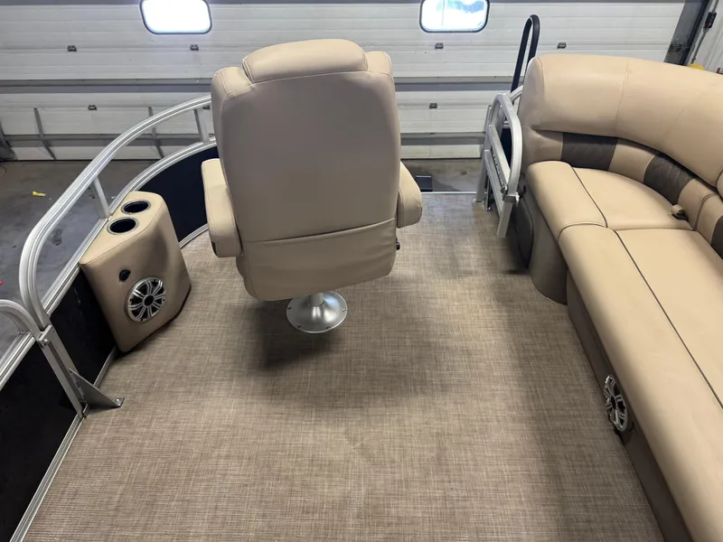 Slide: The Image of 2023 Sun Tracker SportFish 20 DLX interior with beige seating and speaker system. - 20