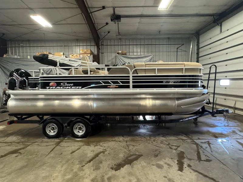 Slide: The Image of 2023 Sun Tracker SportFish 20 DLX pontoon boat in a garage setting. - 3