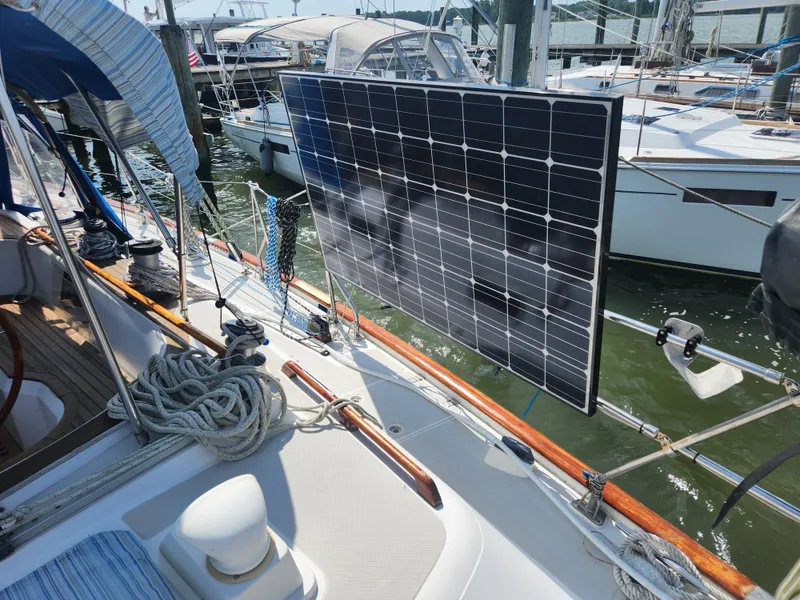 Slide: The Image of 1989 Taswell 43 sailboat with solar panel, docked in a marina. - 13
