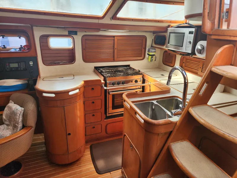 Slide: The Image of Interior of 1989 Taswell 43 yacht kitchen with wood cabinetry, stove, and sink. - 19
