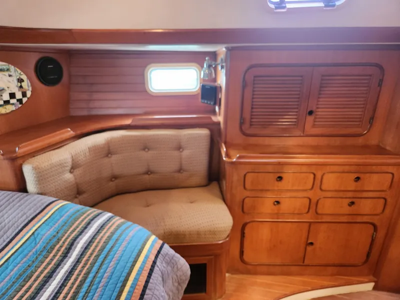 Slide: The Image of Interior of 1989 Taswell 43 yacht with wooden cabinetry and cushioned seating. - 20