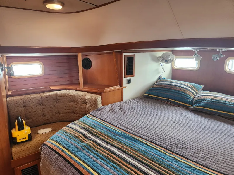 Slide: The Image of Luxurious 1989 Taswell 43 yacht cabin with cozy bed and seating area. - 32