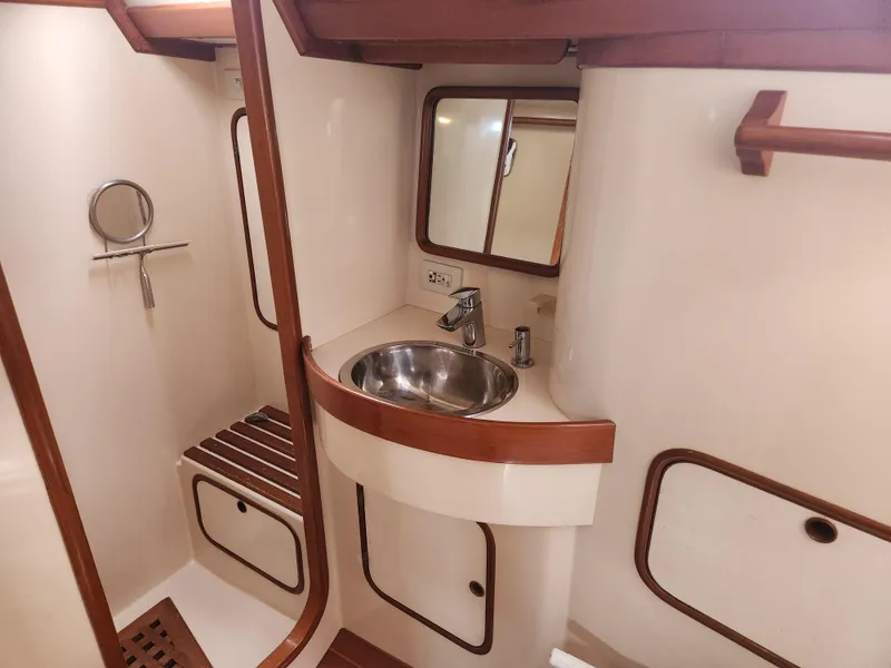 Slide: The Image of 1989 Taswell 43 yacht bathroom with sink, mirror, and wooden accents. - 35