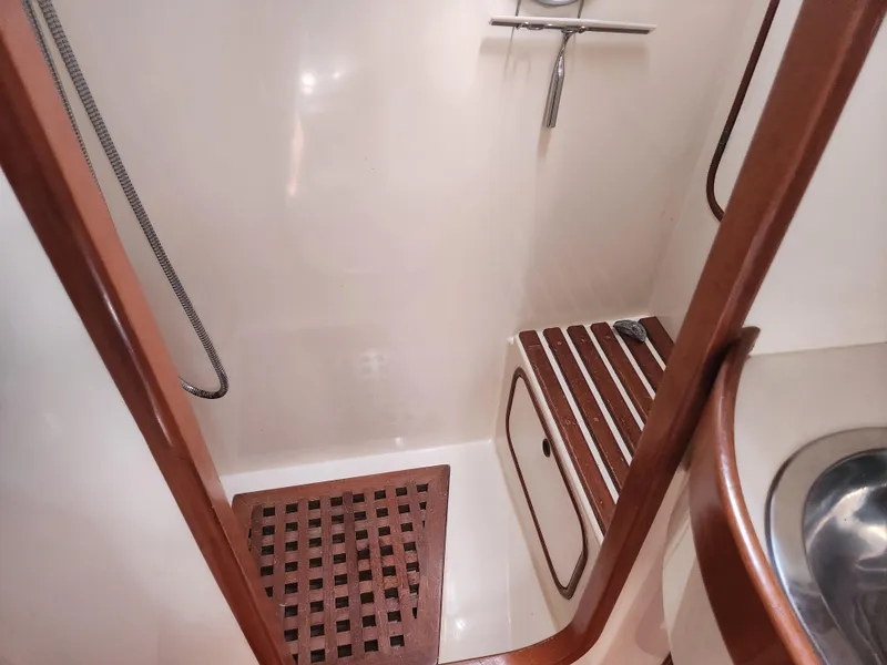 Slide: The Image of Shower area in 1989 Taswell 43 yacht with wooden slats and stainless steel fixtures. - 36