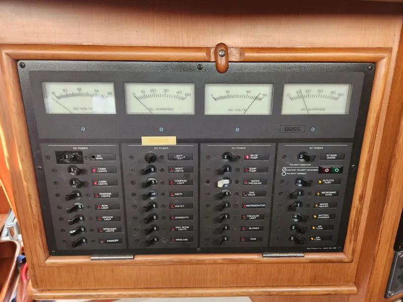 Slide: The Image of Electrical control panel on a 1989 Taswell 43 yacht, featuring volt and amp meters. - 37