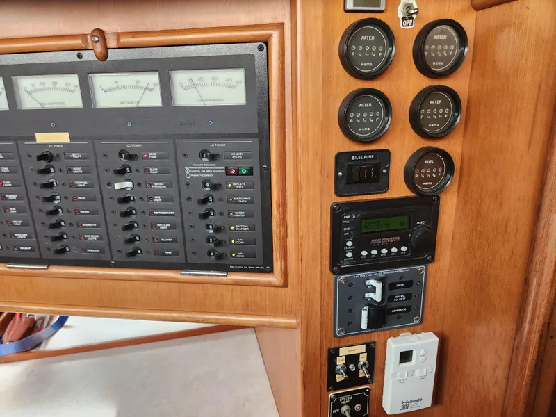 Slide: The Image of Control panel of a 1989 Taswell 43 yacht, featuring gauges and switches. - 38
