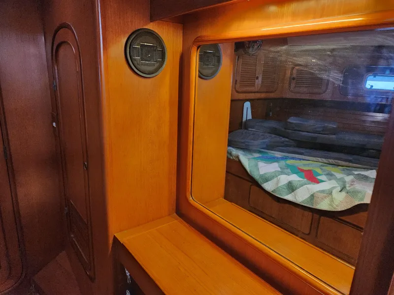 Slide: The Image of Interior of 1989 Taswell 43 yacht with wooden finish and cozy sleeping area. - 41