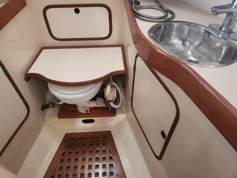 Slide: The Image of 1989 Taswell 43 yacht bathroom with sink, toilet, and wooden accents. - 45