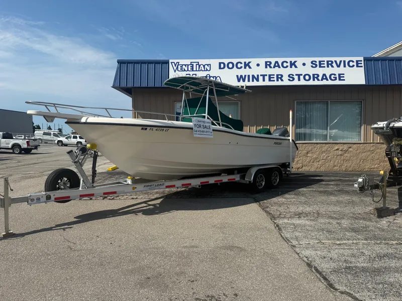 Slide: The Image of 2002 Pursuit 2470 CC boat on trailer, for sale at marina service center. - 17