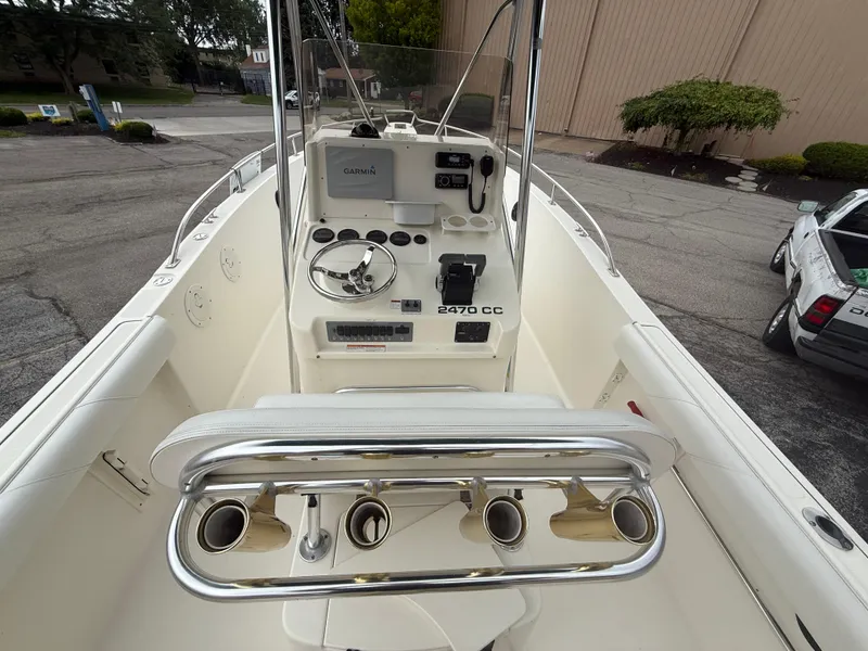 Slide: The Image of 2002 Pursuit 2470 CC boat interior with steering console and rod holders. - 3