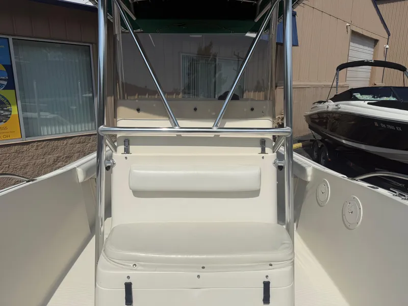 Slide: The Image of 2002 Pursuit 2470 CC boat interior with seating and stainless steel railings. - 9