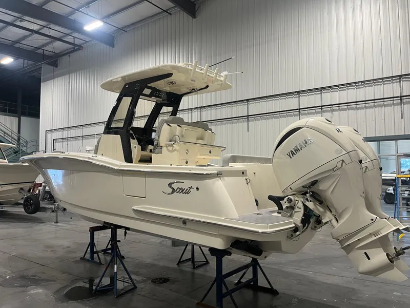 The Image of 2026 Scout 260 LXF boat in a warehouse, side view, elevated on stands. - 0