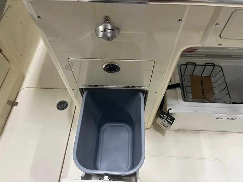 Slide: The Image of 2026 Scout 260 LXF boat interior with storage compartment and cooler. - 10