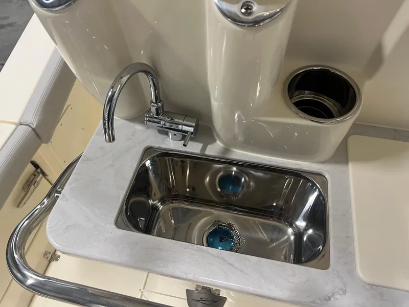 Slide: The Image of 2026 Scout 260 LXF boat sink with faucet and cup holder on deck. - 12