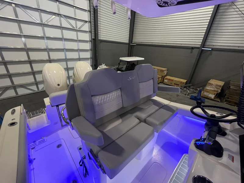 Slide: The Image of 2026 Scout 260 LXF boat interior with dual seats and illuminated cockpit. - 14