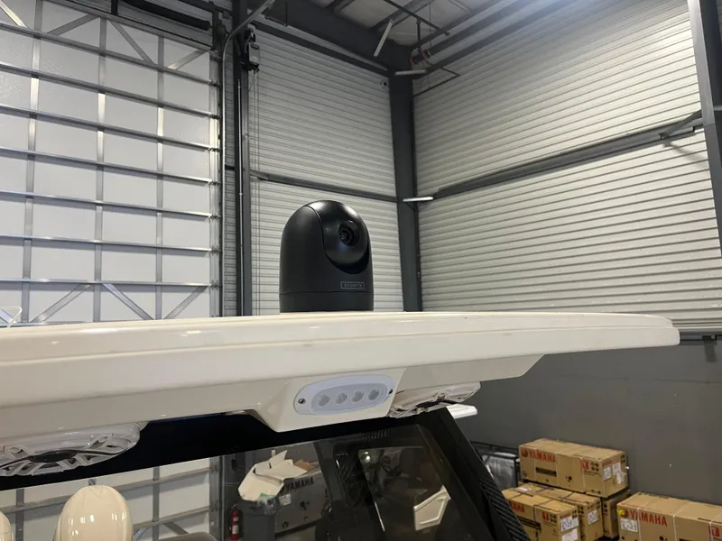 Slide: The Image of 2026 Scout 260 LXF boat with mounted camera in a storage facility. - 23