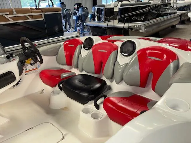 Slide: The Image of 2008 Sea-Doo 150 Speedster boat interior with red and gray seating. - 10