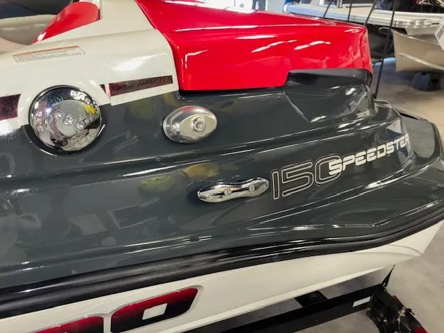 Slide: The Image of 2008 Sea-Doo 150 Speedster boat, red and gray rear view, in a showroom. - 11