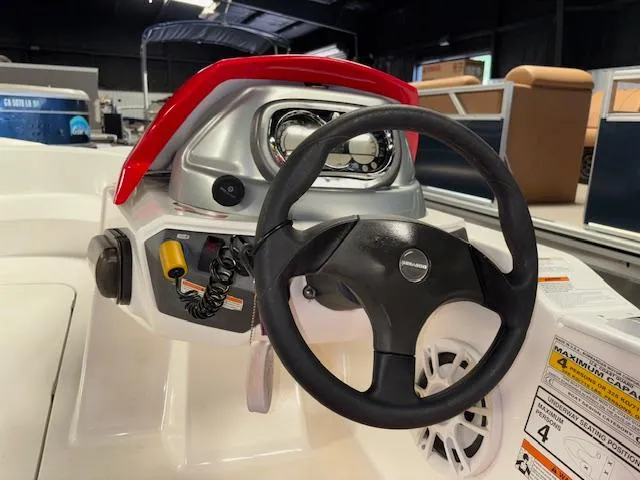 Slide: The Image of 2008 Sea-Doo 150 Speedster dashboard with steering wheel and controls in a showroom. - 12