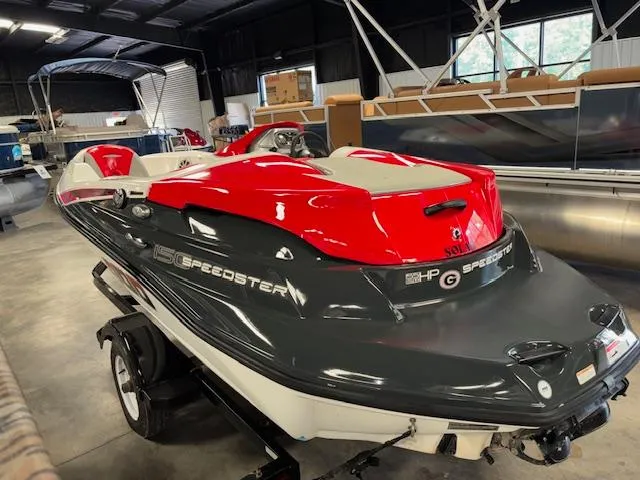 Slide: The Image of 2008 Sea-Doo 150 Speedster boat with red and gray design in a showroom. - 4