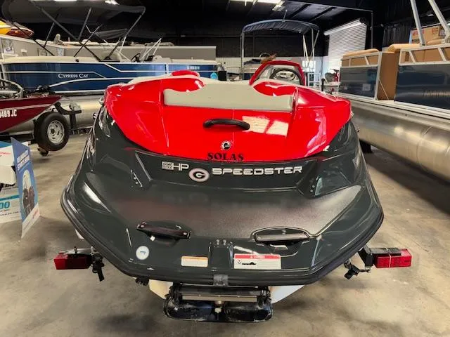 Slide: The Image of 2008 Sea-Doo 150 Speedster boat in showroom, rear view, red and black design. - 5