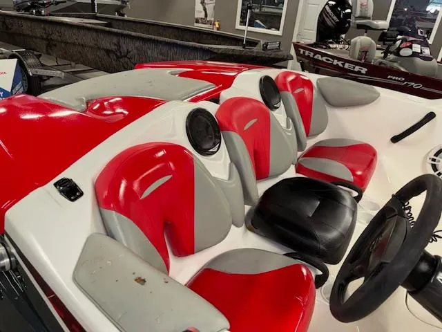 Slide: The Image of 2008 Sea-Doo 150 Speedster boat interior with red and gray seats, steering wheel visible. - 6