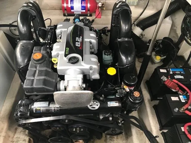 Slide: The Image of Engine compartment of a 2012 Sea Ray 280 Sundancer boat, featuring a powerful 8.2L engine. - 13