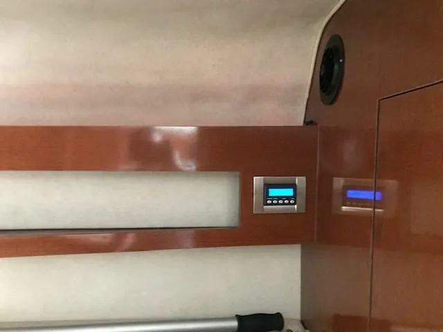 Slide: The Image of Interior of 2012 Sea Ray 280 Sundancer with wood paneling and control panel. - 25