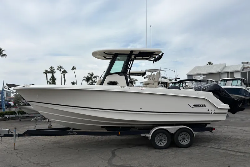 The Image of 2026 Boston Whaler 250 Outrage boat on trailer, parked outdoors. - 0