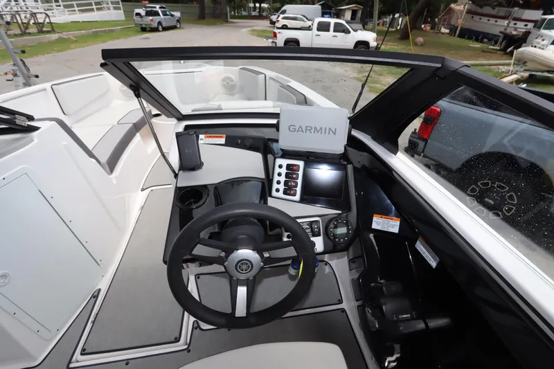 Slide: The Image of 2024 Yamaha Boats SX220 dashboard with Garmin navigation system and steering wheel. - 15