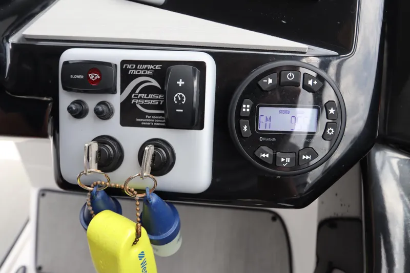 Slide: The Image of 2024 Yamaha SX220 boat dashboard with controls and stereo system. - 17