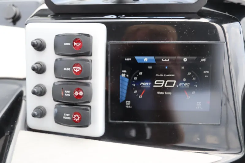 Slide: The Image of 2024 Yamaha Boats SX220 dashboard with control switches and digital display. - 20