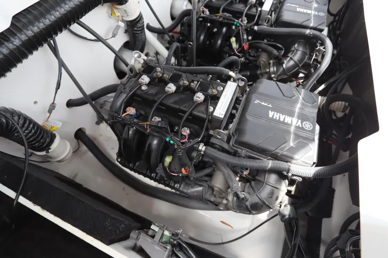 Slide: The Image of 2024 Yamaha Boats SX220 engine compartment with visible wiring and components. - 23