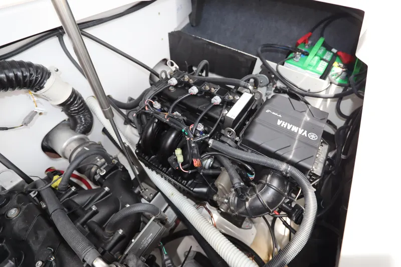 Slide: The Image of 2024 Yamaha Boats SX220 engine compartment with visible components and wiring. - 24