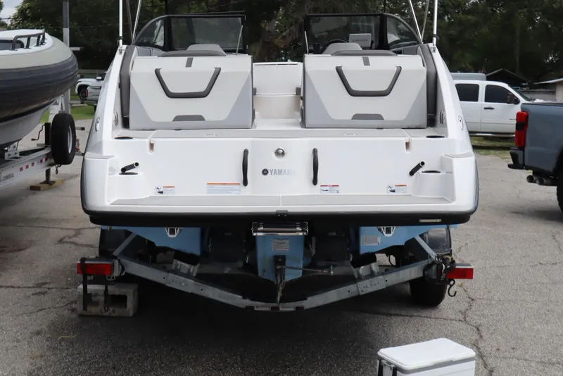 Slide: The Image of 2024 Yamaha Boats SX220 on trailer, rear view, parked outdoors. - 3